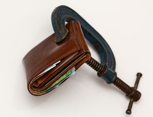 wallet being squeezed by vice