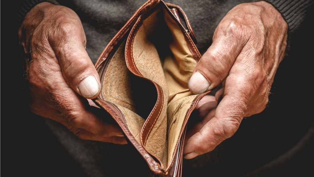 old mans hands holding an open empty wallet